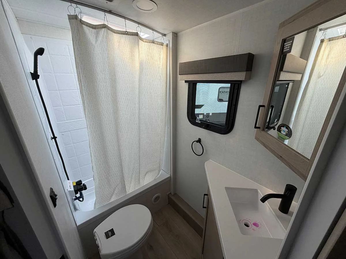 2509S rear bathroom with tub-style shower, toilet, vanity, medicine cabinet and window