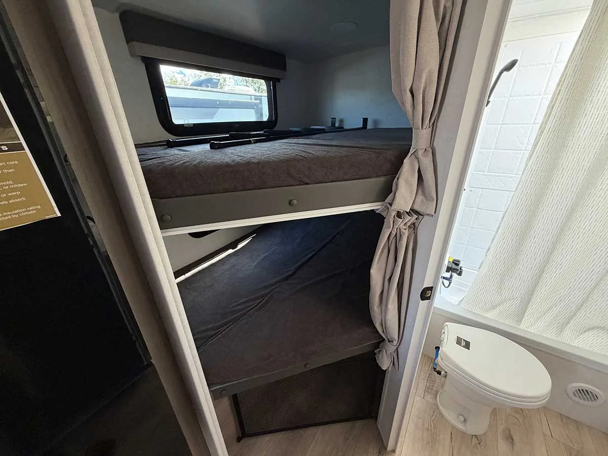 Two double-size bunks stacked in the rear of the 2509S next to the bathroom