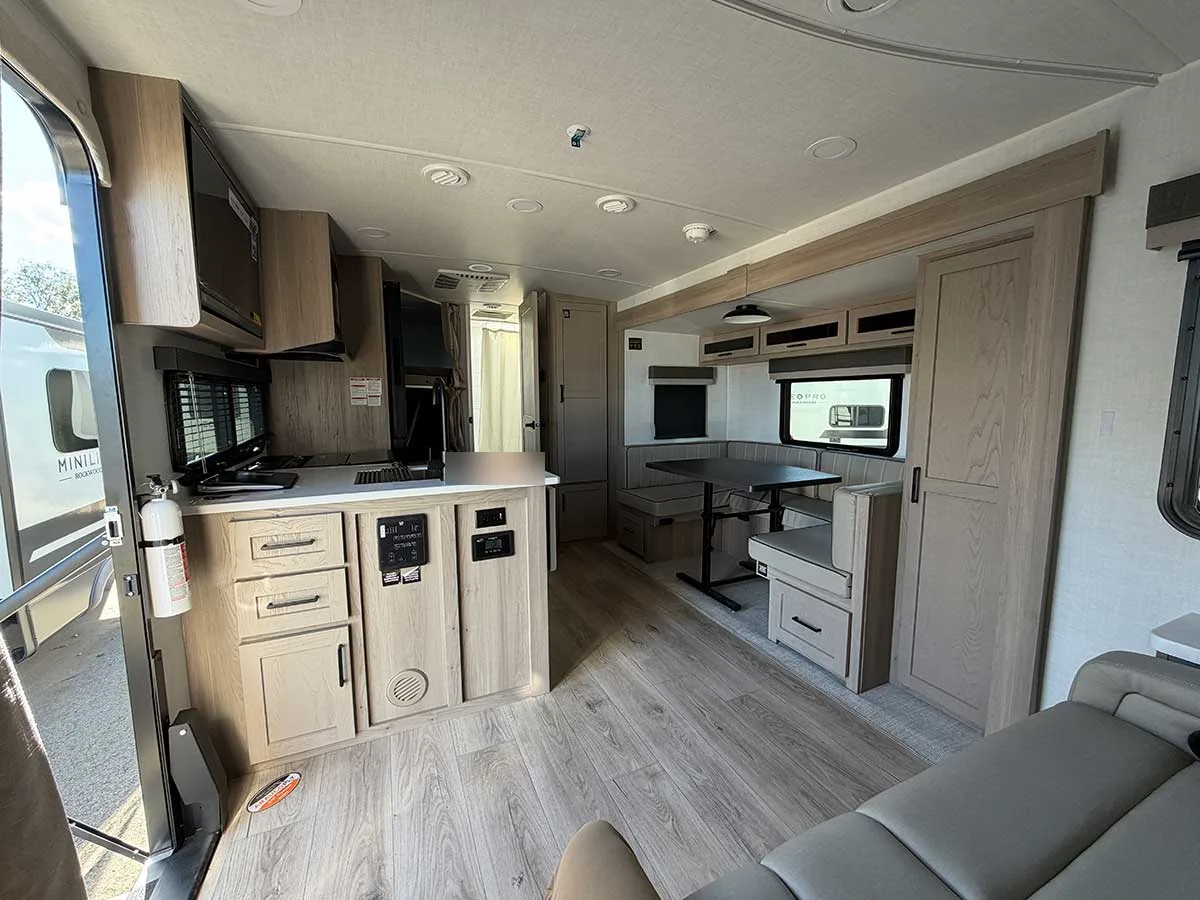 2509S interior from the entry door showing the kitchen island, control panels and U-shaped dinette slide