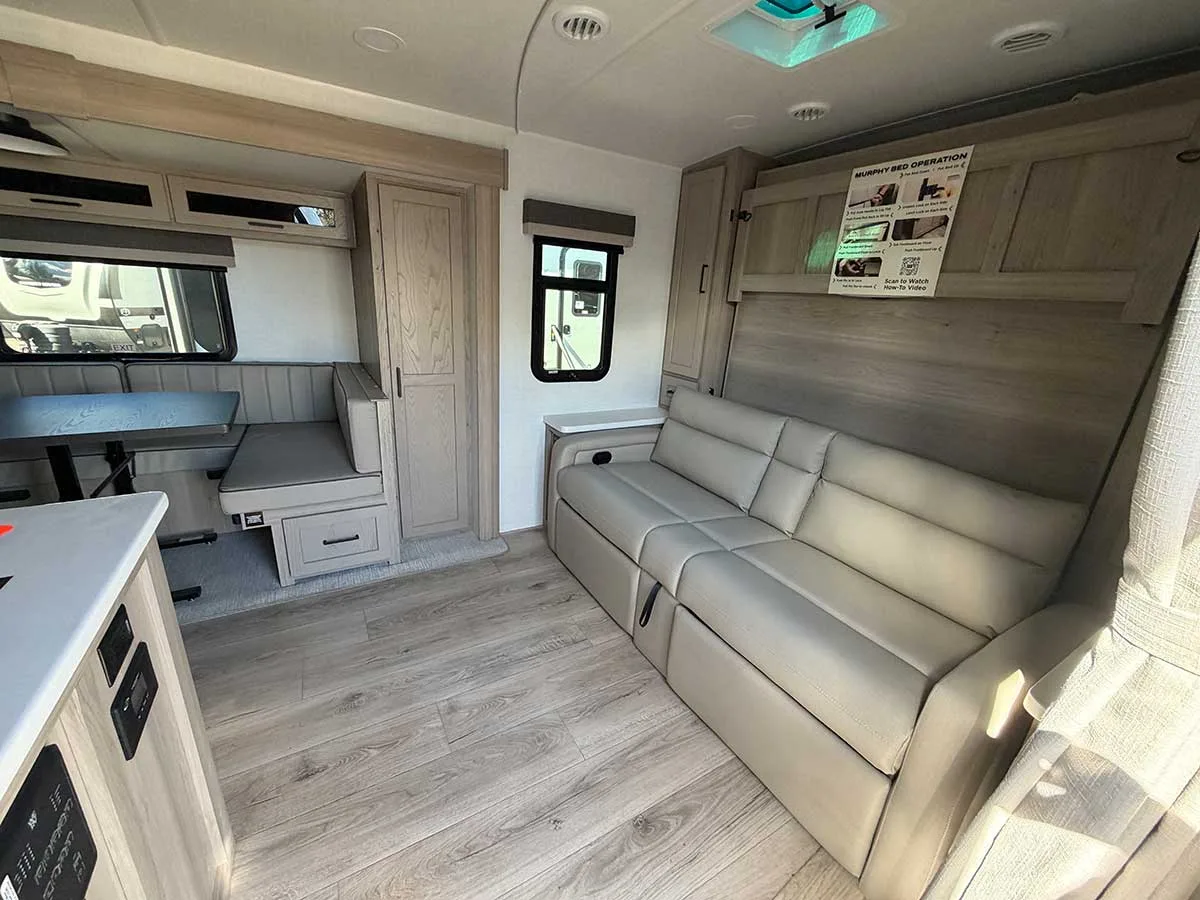 Front sofa in the 2509S with the RV queen Murphy bed folded up behind it and wardrobes on each side
