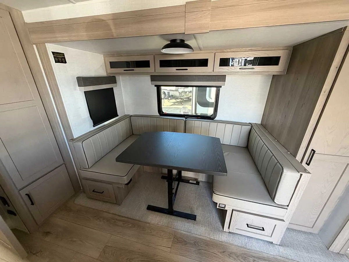 U-shaped dinette in the 2509S slide-out with drawers under the seats and overhead cabinets