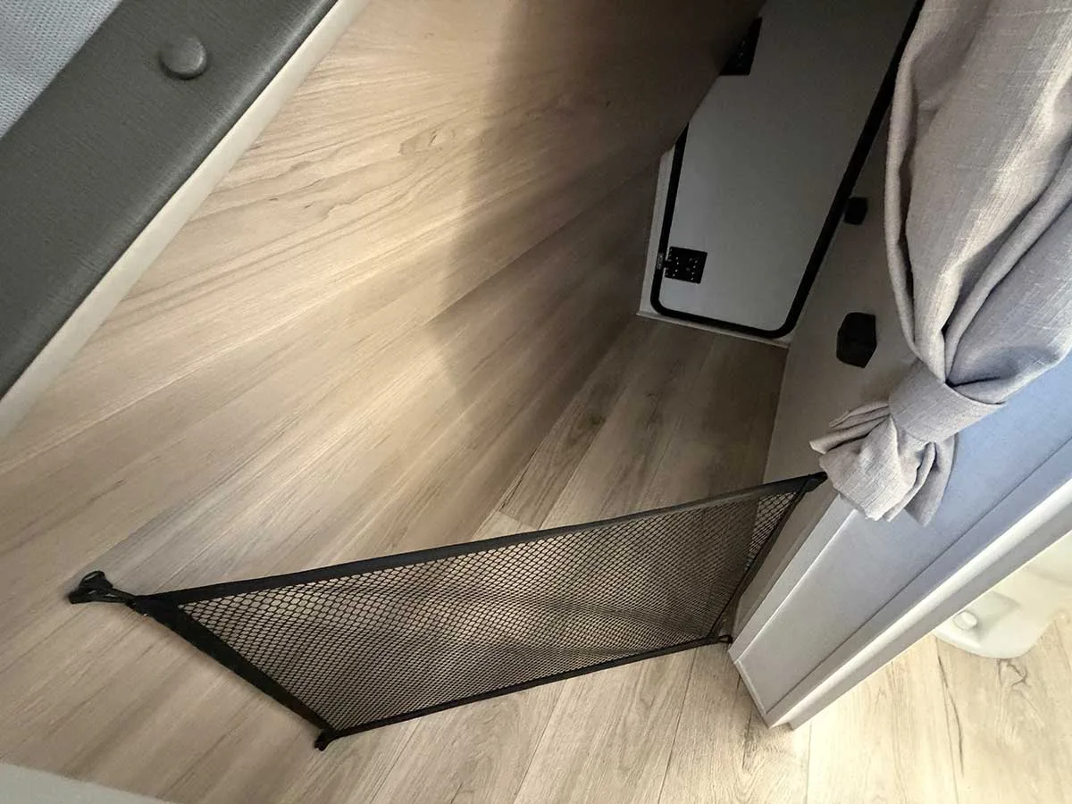 Open floor space under the lower bunk in the 2509S with a cargo net and outside access door