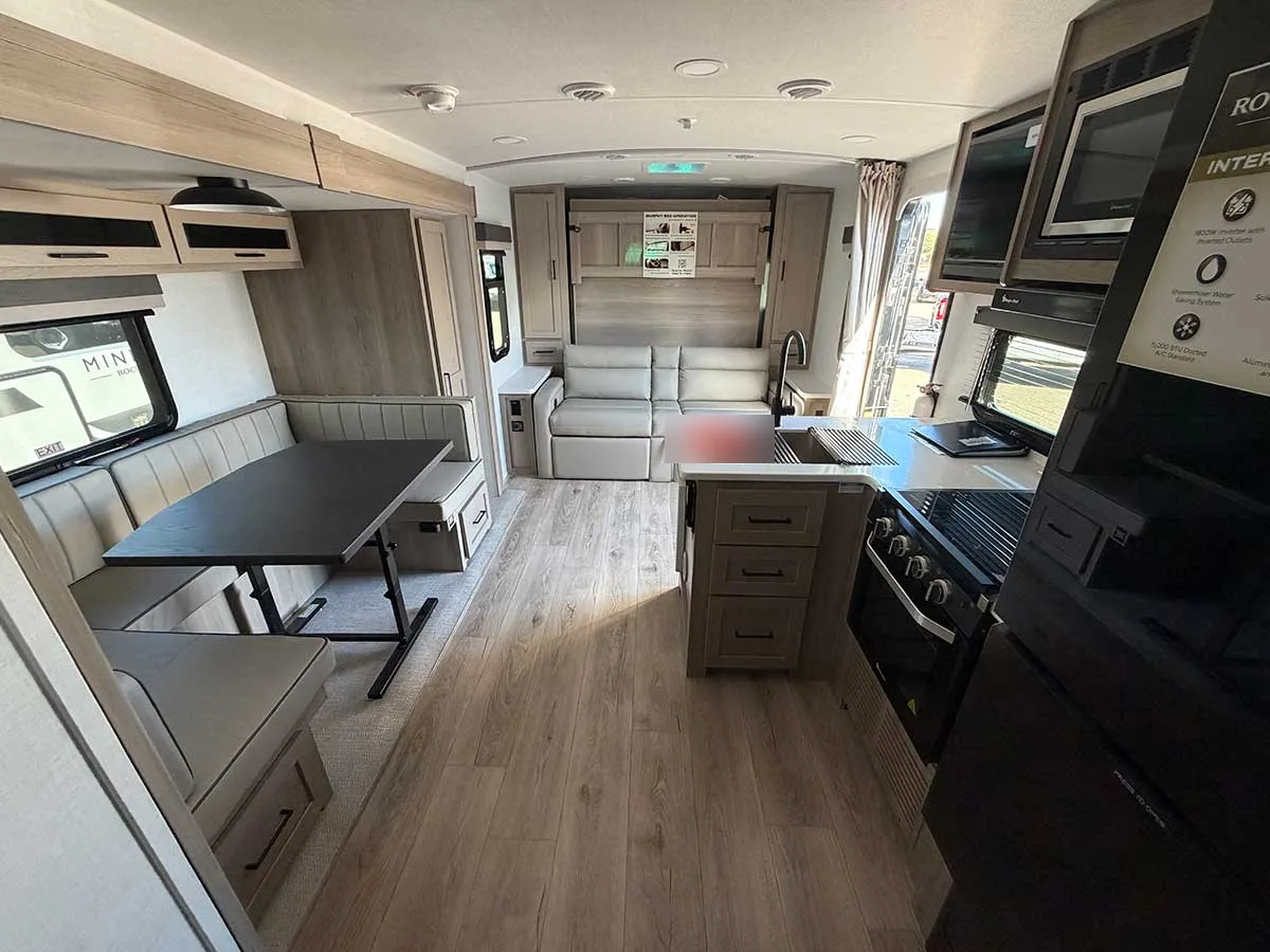 2509S interior looking forward past the kitchen island and U-shaped dinette slide to the sofa and Murphy bed