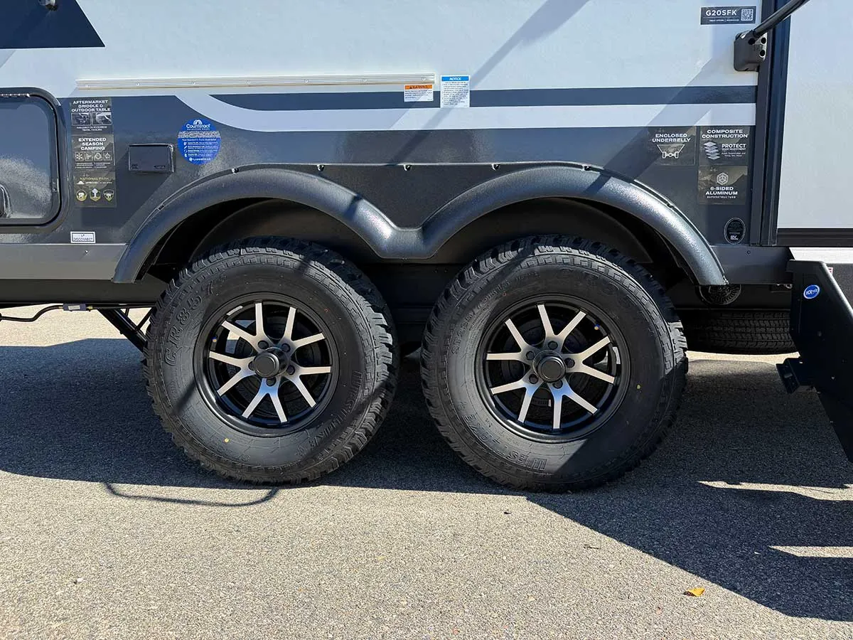 Tandem axles on the Rockwood Geo Pro G20SFK with all-terrain style tires, black machined wheels and fender flares