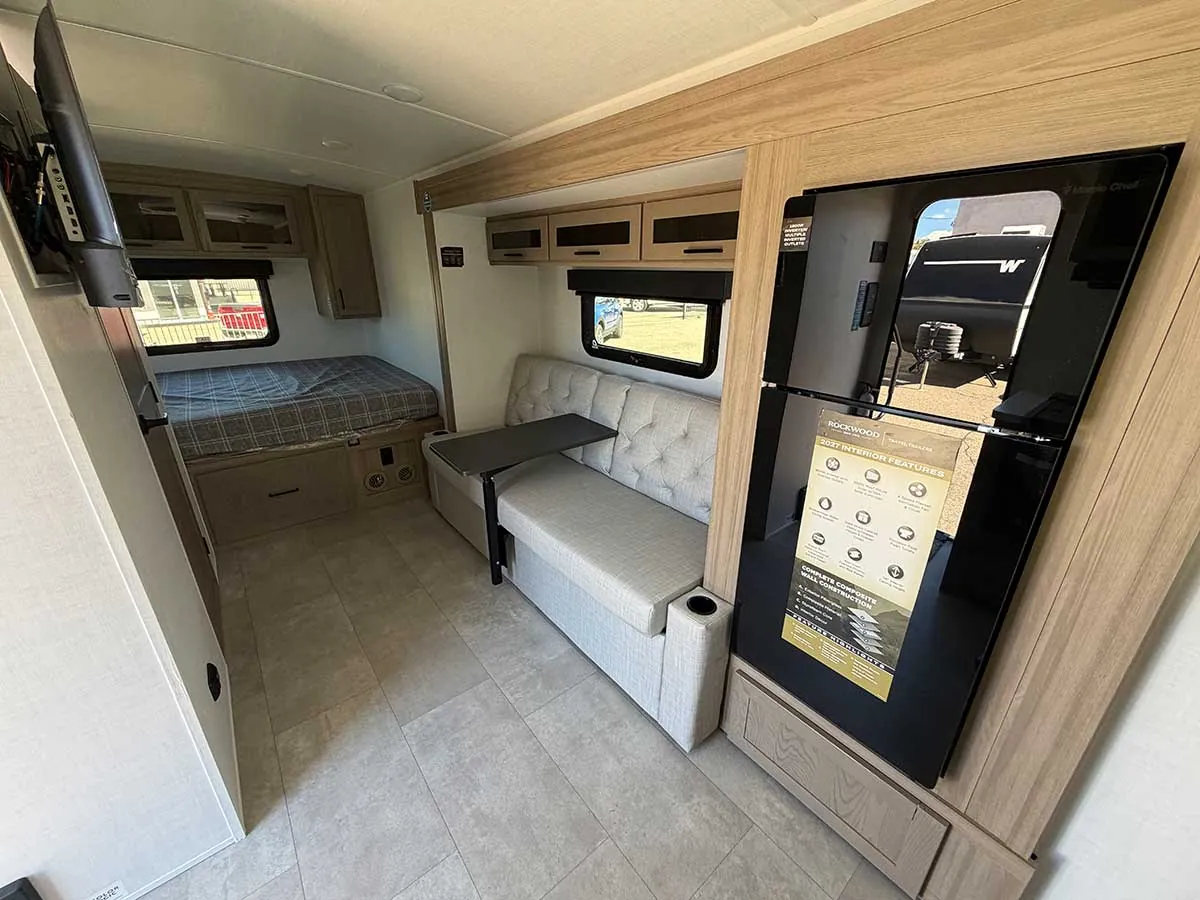 Looking toward the rear bedroom of the G20SFK past the sofa slide and the black glass refrigerator