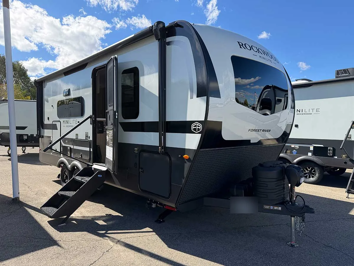 2027 Rockwood Mini Lite 2213S travel trailer, front three-quarter view with fiberglass front cap and wraparound front window