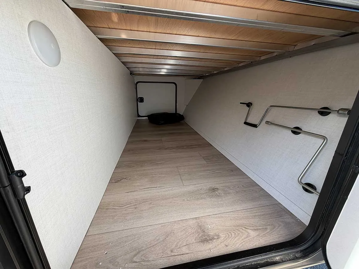 Front pass-through storage bay in the 2213S with a light and finished floor