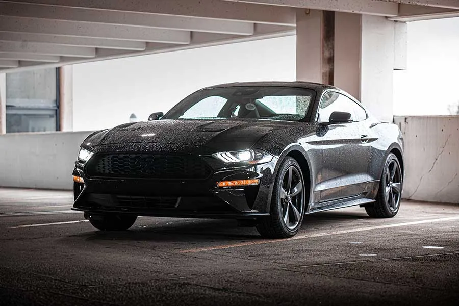 Dark gray Ford Mustang in a parking garage